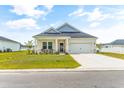 House exterior showcasing a lovely front porch and attached garage at 124 Marley Blue Dr., Little River, SC 29566