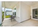 View of the front porch with a small table and chairs at 124 Marley Blue Dr., Little River, SC 29566