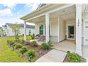 Inviting front porch with sitting area, perfect for relaxing outdoors at 124 Marley Blue Dr., Little River, SC 29566