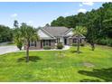 Brick home with palm trees and a large green lawn at 137 Alpharetta Ct., Conway, SC 29526