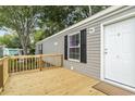 Wooden deck and entrance to gray mobile home at 1533 Sand Dollar Ln., Garden City Beach, SC 29576