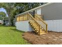 Wooden deck with stairs leading to the mobile home entrance at 1533 Sand Dollar Ln., Garden City Beach, SC 29576