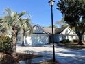 House exterior featuring a palm tree and a lamp post at 201 Melody Gardens Dr., Surfside Beach, SC 29575