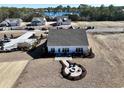 Aerial view of new home with a well manicured backyard including a fire pit with seating at 25 Northbrook Dr, Murrells Inlet, SC 29576