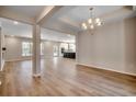 Spacious room with modern flooring, chandelier, and open kitchen and dining area at 25 Northbrook Dr, Murrells Inlet, SC 29576