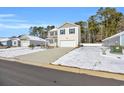 Two-story house with light beige vinyl siding, a white garage door, and a teal front door at 274 Columbus St., Conway, SC 29526