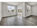 Bright dining room with dark hardwood floors and sliding glass doors at 281 Columbus St., Conway, SC 29526