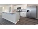 Open concept kitchen with stainless steel appliances, a center island, and gray countertops at 3409 Ashridge Way, Conway, SC 29526