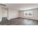 Spacious bonus room with dark gray vinyl plank flooring and large window at 3410 Ashridge Way, Conway, SC 29526