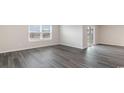 Bright living room featuring gray vinyl plank flooring and sliding glass door access to backyard at 3410 Ashridge Way, Conway, SC 29526