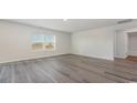 Spacious bonus room with grey vinyl plank flooring and large window at 3415 Ashridge Way, Conway, SC 29526