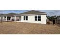 A fenced in backyard with immature lawn, showing the back of a house at 3438 Ashridge Way, Conway, SC 29526