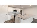 Kitchen island with granite countertop and stainless steel appliances at 3485 Ashridge Way, Conway, SC 29526