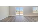 Living room with sliding glass door and hardwood floors at 3497 Ashridge Way, Conway, SC 29526