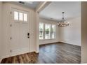 Bright foyer with wood floors, a white front door, and a view into the adjacent dining area at 35 Northbrook Dr, Murrells Inlet, SC 29576
