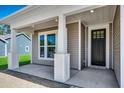 Covered front porch with white columns and trim, offering a welcoming entrance to the home at 35 Northbrook Dr, Murrells Inlet, SC 29576