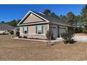 View of a two-car garage with light tan siding at 430 Long Lake Circle, Conway, SC 29527