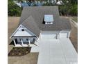 New construction home featuring a brick and siding exterior, three-car garage, and professional landscaping at 45 Northbrook Dr, Murrells Inlet, SC 29576