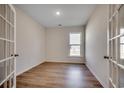 Well-lit room with modern flooring, a large window, and stylish French doors for a versatile space at 45 Northbrook Dr, Murrells Inlet, SC 29576