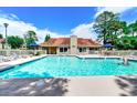 Community pool with lounge chairs and a person enjoying a swim at 500 Myrtle Greens Dr. # A, Conway, SC 29526