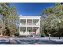 Two-story house with light green exterior, red door, and white columns at 55 Pineberry Dr., Georgetown, SC 29440