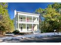 Two-story house with light green exterior, red door, and white columns at 55 Pineberry Dr., Georgetown, SC 29440