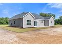 Rear view of a gray sided home with a patio at Tbd Hodges Rd., Conway, SC 29527