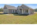 Gray sided home with white trim and landscaping at Tbd Hodges Rd., Conway, SC 29527