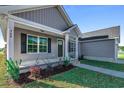 House exterior showcasing a front porch and landscaping at Tbd Hodges Rd., Conway, SC 29527