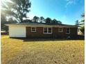Spacious backyard, perfect for outdoor activities and relaxation, with a glimpse of the home's exterior at 109 S Maple Ave., Andrews, SC 29510