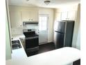 Modern kitchen with stainless steel appliances, white cabinets, and stylish countertops at 109 S Maple Ave., Andrews, SC 29510