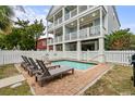 Inviting backyard pool with lounge chairs and a brick patio at 117 A N Dogwood Dr., Surfside Beach, SC 29575