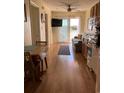 Open living room with kitchen, hardwood floors, and access to a balcony at 2710 Ocean Blvd. S # 406, Myrtle Beach, SC 29577