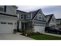 Two-story townhome with gray siding, two-car garage, and landscaping at 325 Golan Circle # 12B, Myrtle Beach, SC 29579