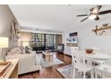 Comfortable living room with hardwood floors, natural light, and sliding glass door to balcony at 415 Ocean Creek Dr. # 2139, Myrtle Beach, SC 29572