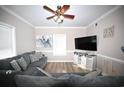 Beach-themed living room with sectional sofa and large TV at 613 Sea Mountain Hwy. # 128, North Myrtle Beach, SC 29582