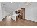 Open-concept kitchen with a large island, stainless steel appliances, and wood flooring flowing into the living area at 626 Lorenzo Dr. # 626, North Myrtle Beach, SC 29582