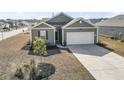 Well-maintained single-story home with green siding, a two-car garage, and neatly landscaped front yard at 775 Oyster Bluff Dr., Myrtle Beach, SC 29588