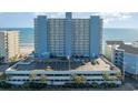 Modern blue high-rise building, with a large parking structure and ocean views at 1012 N Waccamaw Dr. # 1204, Garden City Beach, SC 29576