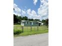 Cute green house with a chain link fence at 109 Plum Ln., Andrews, SC 29510