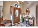Bright and airy entryway with a wooden door and decorative mirror at 1579 Southwood Dr., Surfside Beach, SC 29575