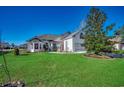 House exterior showcasing a large front yard and mature trees at 1579 Southwood Dr., Surfside Beach, SC 29575