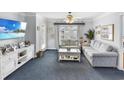 Comfortable living room with sectional sofa and access to balcony at 260 S Crow Creek Dr. # 18, Calabash, NC 28467