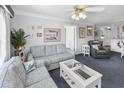 Cozy living area with patterned sofa, coffee table, and large windows at 260 S Crow Creek Dr. # 18, Calabash, NC 28467