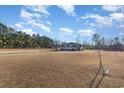 House exterior view with grassy yard and trees at 2647 Coats Rd., Loris, SC 29569