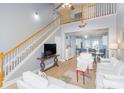 Open living room with a view into the kitchen and a staircase to the upper level at 306 River Rock Ln. # 1304, Murrells Inlet, SC 29576