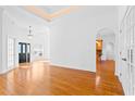 Spacious living room with hardwood floors and an arched doorway at 327 Crooked Gulley Circle, Sunset Beach, NC 28468