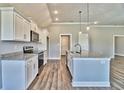 Modern kitchen featuring white cabinets, granite countertops, and stainless steel appliances at 340 William Nobles Rd., Aynor, SC 29511
