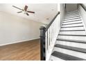 Staircase with black and white railings and wood flooring at 3525 Bristol Ln., Myrtle Beach, SC 29577