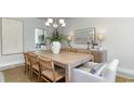 Stylish dining room showcasing a large wood table, seating for eight, and contemporary decor at 378 Glacier Way, Conway, SC 29526